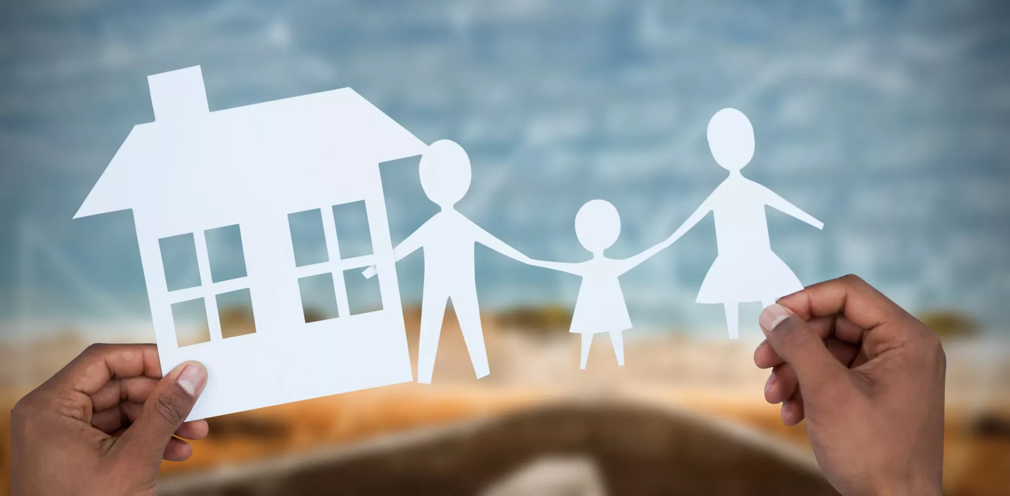 paper cutout of a family with a house